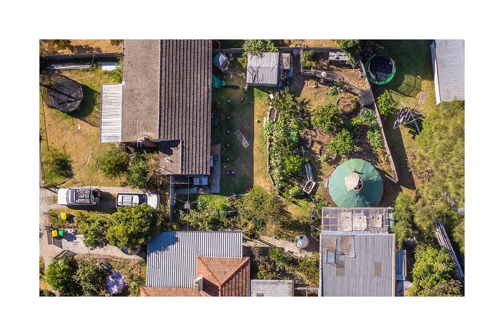 Aerial view of houses and a garden.