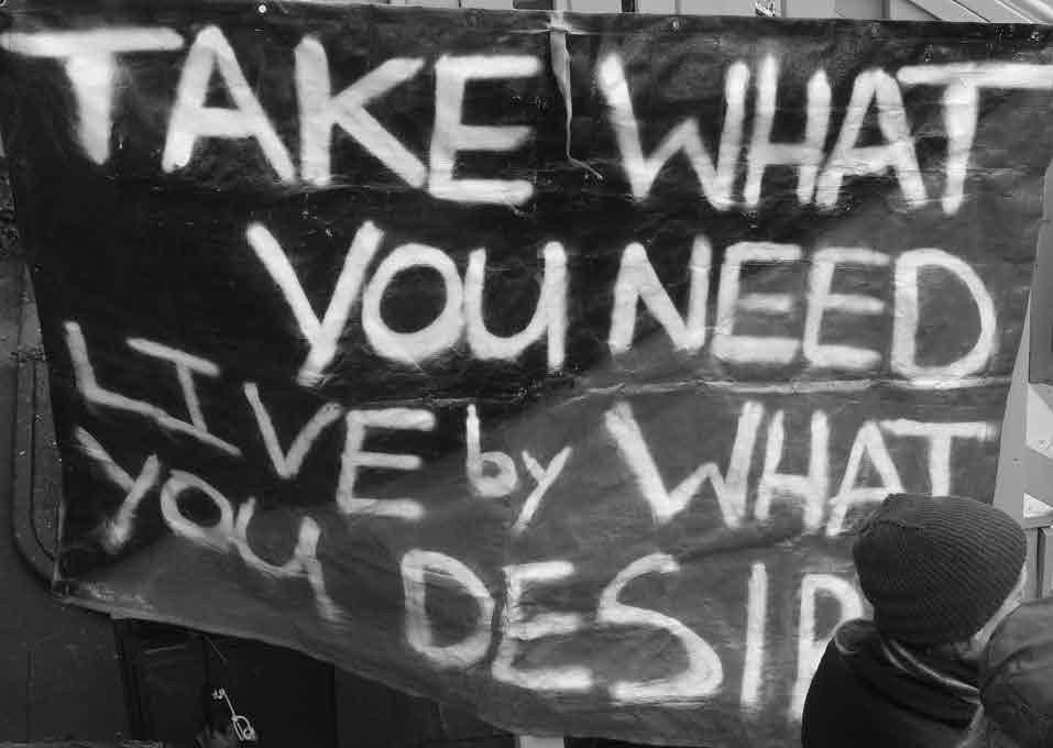 Sign reading "TAKE WHAT YOU NEED LIVE by WHAT YOU DESIRE"
