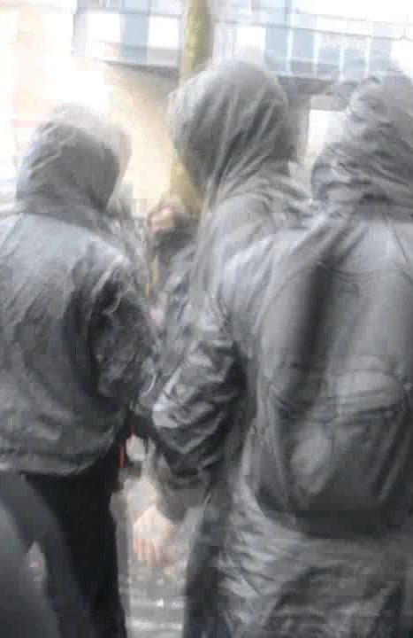 A blurry image of several people in bloc.